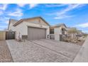 Single-story home with gray garage door and landscaped yard at 8043 E Jaeger St, Mesa, AZ 85207