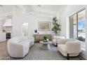 Bright living room with modern furniture, herringbone floors, and seamless flow to the kitchen at 9031 N 83Rd Way, Scottsdale, AZ 85258