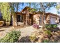 Single-story home with stone accents and a three-car garage at 10022 N Erin Ct, Waddell, AZ 85355