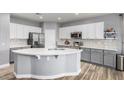 Modern kitchen with gray cabinets, white countertops, and stainless steel appliances at 10022 N Erin Ct, Waddell, AZ 85355