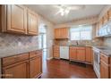 Bright kitchen featuring wood cabinets and granite countertops at 10615 N 102Nd Dr, Sun City, AZ 85351