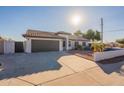 Single-story home with a brown garage door and landscaped yard at 10811 E Contessa St, Mesa, AZ 85207