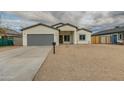 New construction home with gray garage door and neutral colors at 10869 N 81St Ave, Peoria, AZ 85345