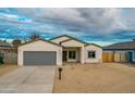 New build home with gray garage door and neutral exterior at 10869 N 81St Ave, Peoria, AZ 85345