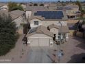 Two-story house with solar panels and a large backyard at 11534 W Longley Ln, Youngtown, AZ 85363