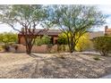 Tan stucco house with a two-car garage and gravel landscaping at 11686 N Spotted Horse Way, Fountain Hills, AZ 85268