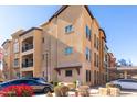 Residential building exterior showcasing architectural details and parking at 14575 W Mountain View Blvd # 12303, Surprise, AZ 85374