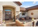 Inviting front patio with seating area and terracotta pots at 15820 W Falcon Ridge Dr, Sun City West, AZ 85375