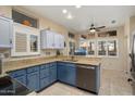 Modern kitchen with blue cabinets, granite countertops, and stainless steel appliances at 15820 W Falcon Ridge Dr, Sun City West, AZ 85375