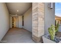 Stylish covered entry featuring neutral colors, decorative column, and a welcoming door at 17527 E Silver Sage Ln, Rio Verde, AZ 85263