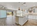 Bright, open kitchen with white cabinets, granite countertops, and a seamless flow to the outdoor patio at 17527 E Silver Sage Ln, Rio Verde, AZ 85263