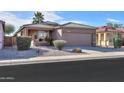 Tan one-story house with a two-car garage and desert landscaping at 1861 E Birch St, Casa Grande, AZ 85122