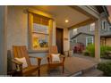 Inviting front porch with wooden chairs and brick flooring at 1926 W Lariat Ln, Phoenix, AZ 85085