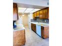 Kitchen with wood cabinets and tile flooring at 19462 N Star Ridge Dr, Sun City West, AZ 85375