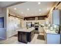 Modern kitchen featuring an island, stainless steel appliances, and white cabinetry at 21413 N 159Th Dr, Sun City West, AZ 85375