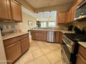 Kitchen featuring wooden cabinets, stainless steel appliances, and a view to the dining area at 26171 W Via Del Sol Dr, Buckeye, AZ 85396