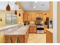 Well-lit kitchen featuring stainless steel appliances and light wood cabinets at 26171 W Via Del Sol Dr, Buckeye, AZ 85396