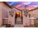 Elegant entry gate with decorative metalwork and arched design at 26222 W Behrend Dr, Buckeye, AZ 85396