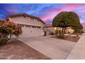 House exterior featuring a two-car garage and desert landscaping at 26222 W Behrend Dr, Buckeye, AZ 85396