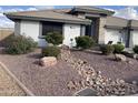 Landscaped front yard with rock garden and drought-tolerant plants at 2705 S Copperwood --, Mesa, AZ 85209