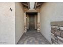 Front entry with a decorative metal door and stone accents at 28210 N Gedona Way, San Tan Valley, AZ 85143