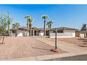 Front view of a remodeled mid-century modern home with a two-car garage at 2826 E Victor Hugo Ave, Phoenix, AZ 85032