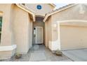 Front entry with a security door and adjacent two-car garage at 29711 N Yellow Bee Dr, San Tan Valley, AZ 85143