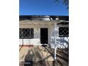 Front entrance with covered porch and black front door at 3028 W Bloomfield Rd, Phoenix, AZ 85029