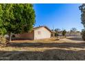 Home's side view, showing backyard and landscaping at 4321 W Greenway Rd, Glendale, AZ 85306