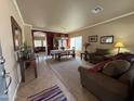 Spacious living room with leather furniture and a view into the dining area at 44152 W Pioneer Rd, Maricopa, AZ 85139