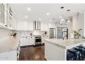 Modern kitchen featuring white cabinets, marble countertops, and stainless steel appliances at 4591 E Calle Ventura --, Phoenix, AZ 85018