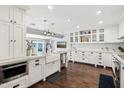 Large kitchen with a farmhouse sink, white cabinetry, and marble countertops at 4591 E Calle Ventura --, Phoenix, AZ 85018