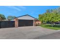 Two-car garage with a modern black door and brick exterior at 4642 N 31St St, Phoenix, AZ 85016