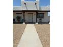 Front entry with walkway, covered porch, and dark brown wooden beams at 50134 W Gail Ln, Maricopa, AZ 85139