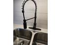 Modern kitchen sink with black faucet and stainless steel basin at 5031 W Flynn Ln, Glendale, AZ 85301