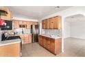 Updated kitchen with light wood cabinets and stainless steel appliances at 5031 W Flynn Ln, Glendale, AZ 85301