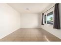 Bright living room featuring tile floors and large window at 5031 W Flynn Ln, Glendale, AZ 85301