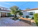 Charming brick courtyard with seating area and lush landscaping at 5989 E Sapphire Ln, Paradise Valley, AZ 85253