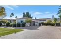 Elegant home with a brick driveway and lush landscaping at 5989 E Sapphire Ln, Paradise Valley, AZ 85253