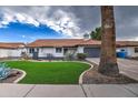 Single story home with a beautifully landscaped front yard at 6017 E Beck Ln, Scottsdale, AZ 85254