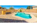 Backyard view showcasing a beautiful private pool and brick pavers at 6410 W Hughes Dr, Phoenix, AZ 85043