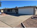 Single story home with attached garage and landscaped yard at 6449 E Dodge St, Mesa, AZ 85205