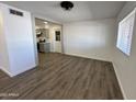 Bright and airy living area showcasing vinyl flooring and an open layout at 6449 E Dodge St, Mesa, AZ 85205