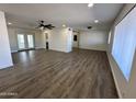 Spacious living room features new vinyl flooring, modern ceiling fan and lots of natural light at 6449 E Dodge St, Mesa, AZ 85205