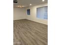 Bright living room featuring hardwood floors and large windows at 6449 E Dodge St, Mesa, AZ 85205