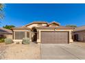 One-story house with brown garage door and desert landscaping at 6612 W Paso Trl, Phoenix, AZ 85083