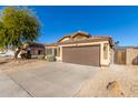 One story house with brown garage door, solar panels, and desert landscaping at 6612 W Paso Trl, Phoenix, AZ 85083