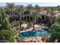 Luxury estate with pool, expansive grounds, and palm trees at 6876 S Star Dr, Gilbert, AZ 85298