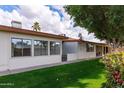 Side view of a single-story home with a grassy lawn at 8020 E Keats Ave # 327, Mesa, AZ 85209