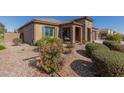 Landscaped front yard showcasing a charming curb appeal at 8202 W Merriweather Way, Florence, AZ 85132